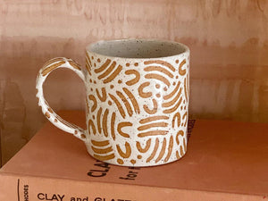 Handmade ceramic mug in speckled clay, glazed with white hand-painted dash wax resist pattern